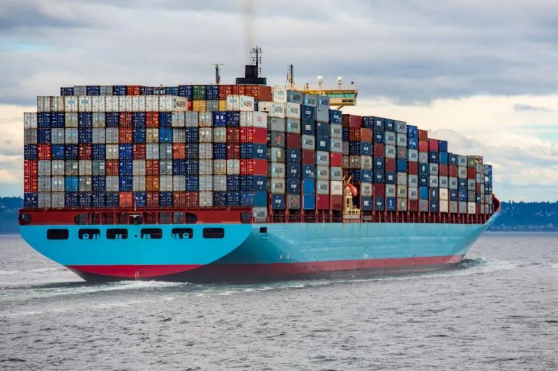 Container ship at sea under an overcast sky